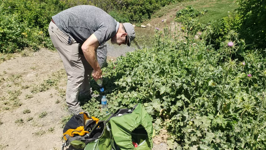 Jeff is manually forcing the stream water through the filtration device.