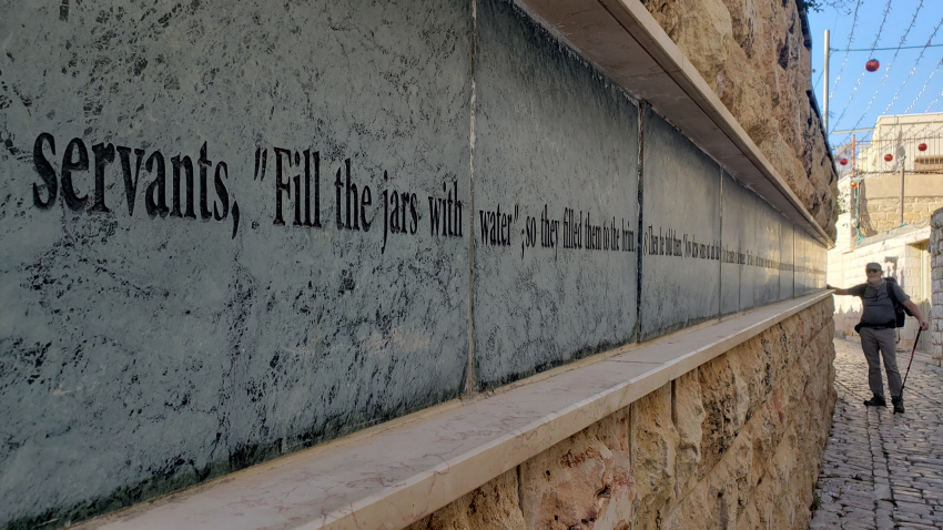 The Bible verse recounting the water-to-wine miracle is chisled on the wall outside the church.