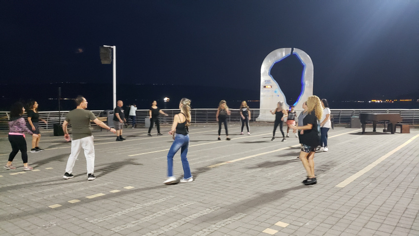People line dancing to pretty Israeli music.