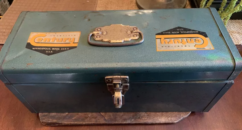 Vintage toolboxes and brooches. 