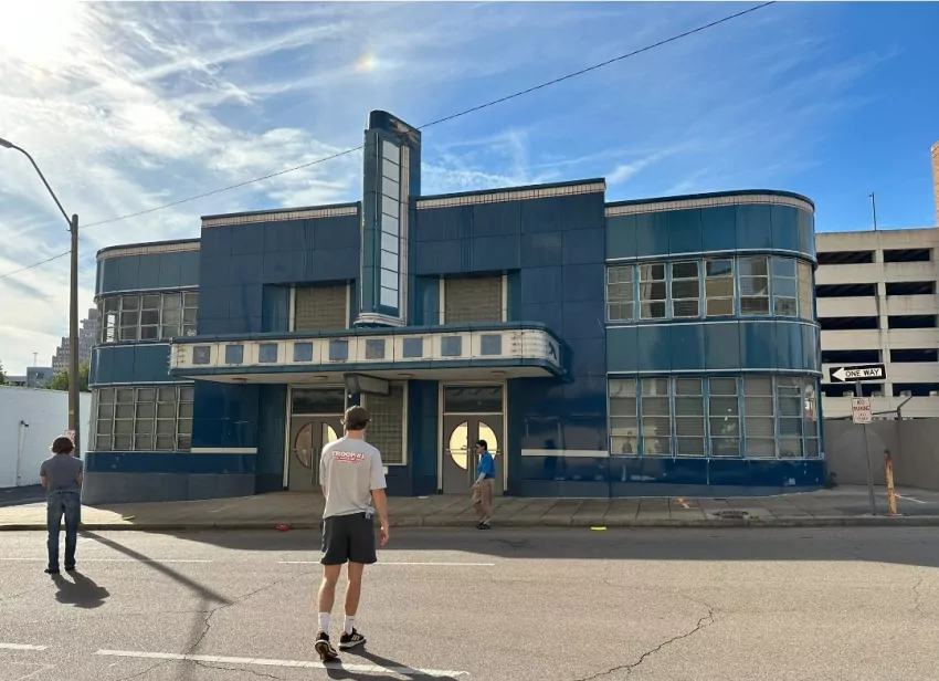 Around a corner, then hit the doors to the old bus station. 