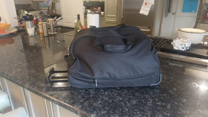Carry on duffle bag on wheels is all I took. You can stuff it under your seat if need be. 