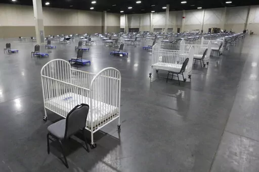 Cots and cribs are arranged at the Mountain America Expo Center in Sandy, Utah, on April 6, 2020, as an alternate care site or for hospital overflow amid the COVID-19 pandemic. According to a National Center for Health Statistics report released on Wednesday, Feb. 23, 2022, maternal mortality rates for U.S. women climbed higher in the pandemic's first year, continuing a trend that disproportionately affects Black mothers. (AP Photo/Rick Bowmer, File)