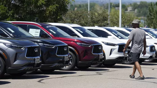A prospective buyer surveys a row of unsold 2023 QX60 luxury sports-utility vehicles at an Infiniti dealership Sunday, Aug 27, 2023, in Highlands Ranch, Colo. (AP Photo/David Zalubowski, File)
