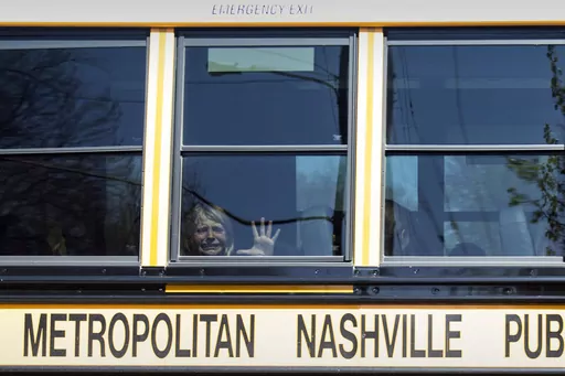 A child weeps while on the bus leaving The Covenant School following a mass shooting at the school in Nashville, Tenn., Monday, March 27, 2023. A 28-year-old killed three children and three adults in a shooting at a small Christian elementary school before being killed by police. The shooter was a former student there. Police have said the shooter “was assigned female at birth” but used masculine pronouns on social media. (Nicole Hester/The Tennessean via AP, File)