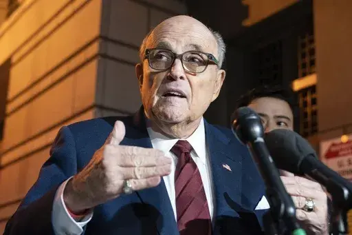 Former New York Mayor Rudy Giuliani talks to reporters as he leaves the federal courthouse in Washington, Dec. 11, 2023. A judge said Wednesday, July 10, 2024, he was leaning toward throwing out Giuliani's bankruptcy case after lawyers and his biggest creditors agreed this was the best way forward. (AP Photo/Jose Luis Magana, File)