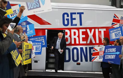 Britain's Prime Minister Boris Johnson addresses his supporters prior to boarding his General Election campaign trail bus in Manchester, England, Friday, Nov. 15, 2019. The moving vans have already started arriving in Downing Street, as Britain's Conservative Party prepares to evict Johnson. Debate about what mark he will leave on his party, his country and the world will linger long after he departs in September. (AP Photo/Frank Augstein, Pool, File)