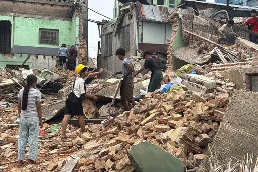 People clean debris from damaged buildings in the aftermath of an earthquake on March 28, in Naypyitaw, Myanmar, Monday, April 7, 2025. (AP Photo)