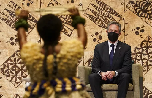 U.S. Secretary of State Antony Blinken watches a cultural farewell ceremony in Nadi, Fiji, Saturday, Feb. 12, 2022. (Kevin Lamarque/Pool Photo via AP)
