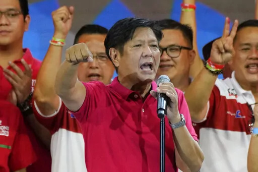 Presidential hopeful, former senator Ferdinand "Bongbong" Marcos Jr., the son of the late dictator, gestures as he greets the crowd during a campaign rally in Quezon City, Philippines on April 13, 2022. Marcos Jr.'s apparent landslide victory in the Philippine presidential election is giving rise to immediate concerns about a further erosion of democracy in the region, and could complicate American efforts to blunt growing Chinese influence and power in the Pacific. (AP Photo/Aaron Favila, File)