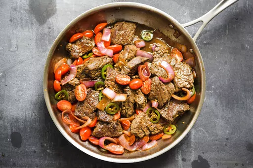 This image released by Milk Street shows a recipe for Lomo Saltado. (Milk Street via AP)