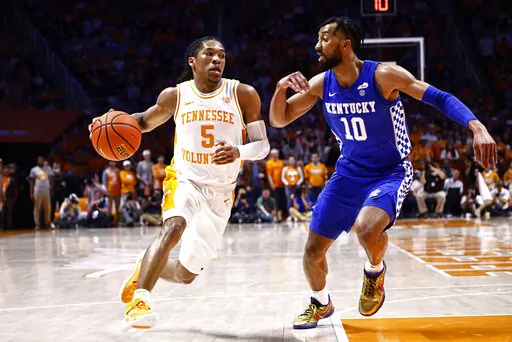 Tennessee guard Zakai Zeigler (5) drives against Kentucky guard Davion Mintz (10) during the first half of an NCAA college basketball game Tuesday, Feb. 15, 2022, in Knoxville, Tenn. (AP Photo/Wade Payne)