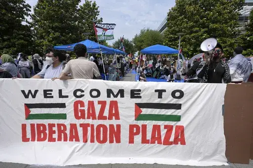 People gather to protest against the Israel-Hamas war at a plaza at the University of Texas at Dallas, Wednesday, May 1, 2024, in Richardson, Texas. (AP Photo/LM Otero, File)