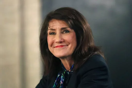 In this March 9, 2020, photo, Democrat Marie Newman campaigns in Chicago. A congressional ethics watchdog has concluded that U.S. Reps. Marie Newman of Illinois and Doug Lamborn of Colorado may have violated federal law, prompting reviews from the House Ethics Committee. (AP Photo/Charles Rex Arbogast, File)