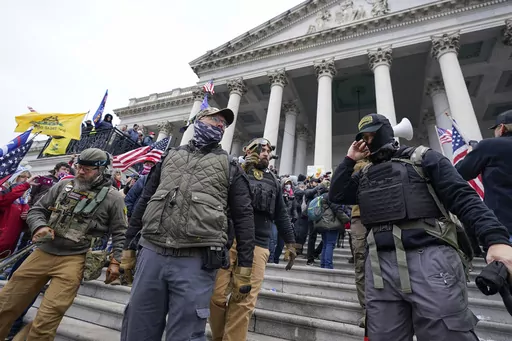 Members of the Oath Keepers extremist group stand on the East Front of the U.S. Capitol on Jan. 6, 2021, in Washington. David Moerschel, a 45,-year-old neurophysiologist from Punta Gorda, Fla., and Joseph Hackett, a 52-year-old chiropractor from Sarasota, Fla., who stormed the U.S. Capitol with other members of the far-right Oath Keepers group, were sentenced Friday to three years in prison for seditious conspiracy and other charges, the latest in a historic string of sentences in the Jan. 6. 20