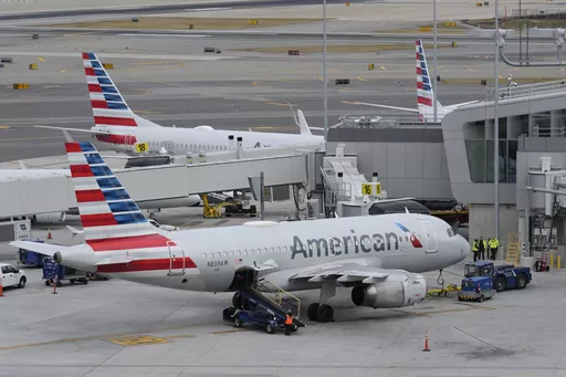 American Airlines planes sit on the tarmac at Terminal B at LaGuardia Airport, Jan. 11, 2023, in New York. American Airlines is raising bag fees and pushing customers to buy tickets directly from the airline if they want to earn frequent-flyer points. American said Tuesday, Feb. 20, 2024, that checking a bag on domestic flights will rise from $30 now to $35 online, and it'll be $40 if purchased at the airport. (AP Photo/Seth Wenig, File)