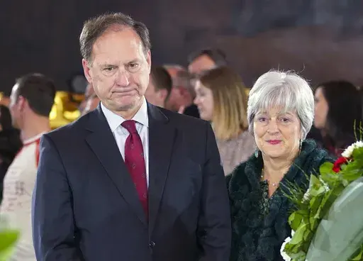 Supreme Court Justice Samuel Alito Jr., left, and his wife Martha-Ann Alito, pay their respects at the casket of Reverend Billy Graham at the Rotunda of the U.S. Capitol Building in Washington, Feb. 28, 2018. An upside-down American flag was displayed outside of Alito's home Jan. 17, 2021, days after former President Donald Trump supporters stormed the U.S. Capitol, The New York Times reports. It's a symbol associated with Trump's false claims of election fraud. "It was briefly placed by Mrs. Al