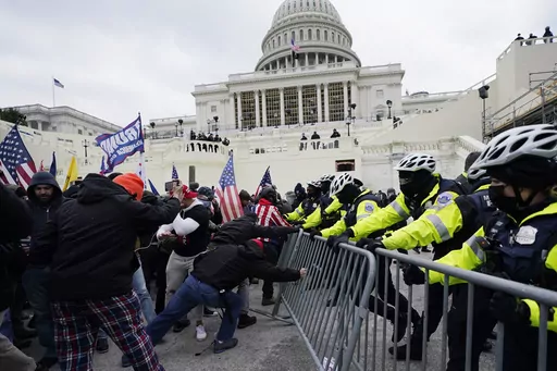 Rioters loyal to President Donald Trump push against a line of police at the U.S. Capitol in Washington on Jan. 6, 2021. House Republicans are aiming to undercut the Jan. 6 Committee's investigation with a new report that they say contradicts some of key testimony given to the panel. (AP Photo/Julio Cortez, File)