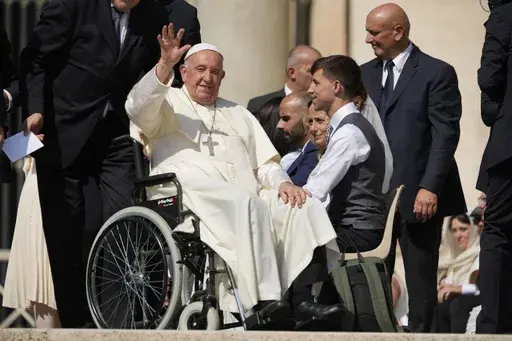 FILE-- Pope Francis waves as he leaves after his weekly general audience in St. Peter's Square at The Vatican, Aug. 28, 2024. (AP Photo/Andrew Medichini, File)
