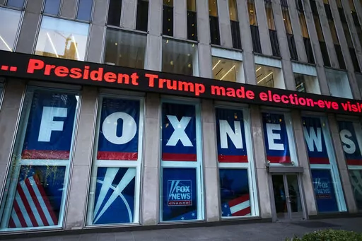 A headline about President Donald Trump is displayed outside Fox News studios, on Nov. 28, 2018, in New York. On Thursday, Feb. 16, the voting machine company Dominion filed court papers documenting that numerous Fox News personalities knew there was no evidence to support the claims peddled by Trump's allies, but aired them anyway on the nation's most-watched cable network. (AP Photo/Mark Lennihan, File)