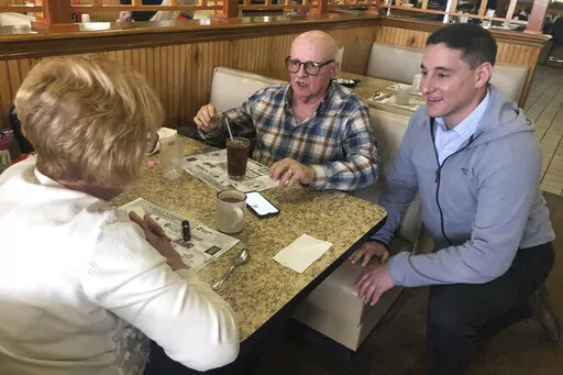 Republican Senate candidate Josh Mandel chats with Star and Bruce Clark at Canary's Family Restaurant in North Olmsted, Ohio, March 9, 2022.  Ohio's crowded Republican Senate race has been all about one man: Donald Trump. But with less than two months until the state's May 3 primary to succeed retiring Sen. Rob Portman, some of the leading candidates have accepted that, despite their best efforts, the former president's coveted endorsement may never come. (AP Photo/Jill Colvin)