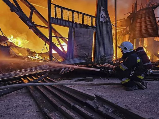 In this photo provided by the Ukrainian Emergency Service, emergency services personnel work to extinguish a fire following a Russian attack in Lviv, Ukraine, Tuesday, Sept. 19, 2023. (Ukrainian Emergency Service via AP)