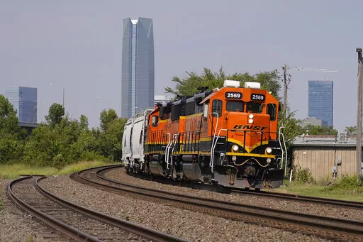 A BNSF locomotive heads south out of Oklahoma City, Wednesday, Sept. 14, 2022. A fifth rail union has approved its deal with the freight railroads to secure 24% raises and $5,000 in bonuses and a sixth one is set to vote Thursday. But all 12 rail unions must ratify their contracts to prevent a strike. (AP Photo/Sue Ogrocki, File)