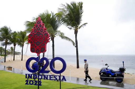 A police officer walks past a G20 sign in Nusa Dua, Bali, Indonesia, Thursday, July 7, 2022. Foreign ministers from the Group of 20 leading rich and developing nations are gathering in Indonesia's resort island of Bali for talks bound to be dominated by the conflict in Ukraine despite an agenda focused on global cooperation and food and energy security. (AP Photo/Dita Alangkara)