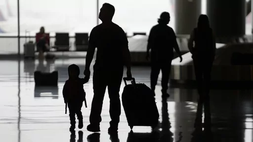 People travel through Salt Lake City International Airport on Wednesday, Feb. 22, 2023, in Salt Lake City. When discussing a multigenerational family trip, have a plan to avoid arguments around topics like when to travel, where you’ll go, what you’ll do there or how you’ll split bills. With groups, it’s often best for each family unit to book their lodging and transportation. (AP Photo/Rick Bowmer, File)