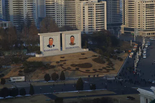 Portraits of late North Korean leaders Kim Il Sung and Kim Jong Il sit in downtown Pyongyang, North Korea on Dec. 19, 2018. North Korea is continuing to steal hundreds of millions of dollars from financial institutions and cryptocurrency firms and exchanges, illicit money that is an important source of funding for its nuclear and missile programs, U.N. experts said in a report quoting cyber specialists. (AP Photo/Dita Alangkara, File)