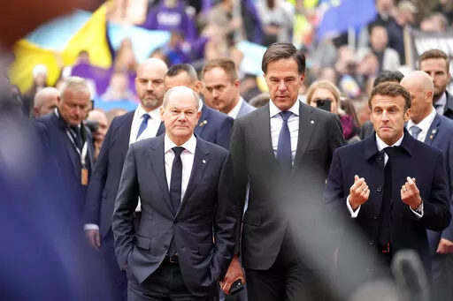 From left, Germany's Chancellor Olaf Scholz, Netherland's Prime Minister Mark Rutte and French President Emmanuel Macron arrive for an EU Summit at Prague Castle in Prague, Czech Republic, Friday, Oct 7, 2022. European Union leaders enter a crucial stretch this week to make sure runaway energy prices and short supplies do not further tank their struggling economies and foment unrest. At the same time, they need to keep all 27 members united in their opposition of Russian President Vladimir Putin