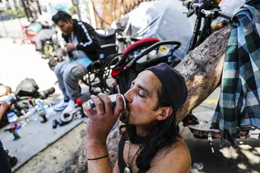 A homeless man named Angel drinks a soda to keep cool during a heat wave in San Francisco on Wednesday, July 3, 2024. (Gabrielle Lurie/San Francisco Chronicle via AP)