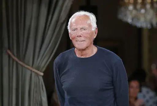 Designer Giorgio Armani accepts applause at the end of the Armani Haute Couture Fall-Winter 2018/2019 fashion collection presented Tuesday, July 3, 2018, in Paris. Milan fashion stalwart Giorgio Armani celebrated his 90th birthday on Thursday, July 11, 2024, just like any other day — at work. The designer told the Milan daily Corriere della Sera that “I couldn't live my life any other way.” (AP Photo/Michel Euler, File)