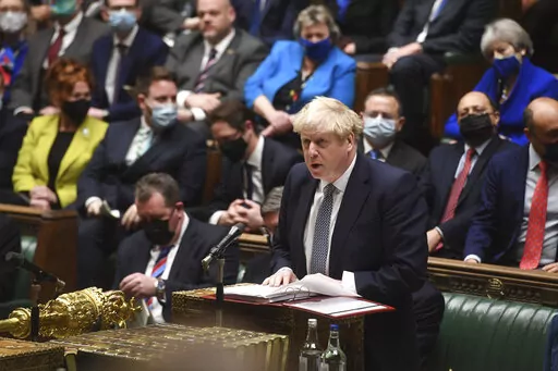 In this photo provided by UK Parliament, Britain's Prime Minister Boris Johnson speaks during Prime Minister's Questions in the House of Commons, in London, Wednesday, Jan. 12, 2022. Johnson has apologized for attending a garden party during Britain’s first coronavirus lockdown, but brushed aside opposition demands that he resign for breaching the rules his own government had imposed on the nation. The apology Wednesday stopped short of admitting wrongdoing. It was Johnson’s attempt to assua