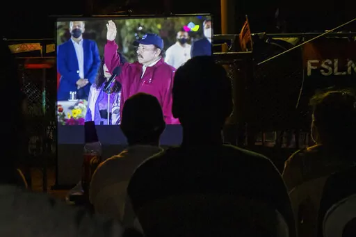 Residents watch the inauguration of current President Daniel Ortega, for is fourth consecutive term, on a giant screen set up at a park in the Julio Buitrago neighborhood of Managua, Nicaragua, Jan. 10, 2022. The Biden administration is considering trying to expel Nicaragua from a lucrative regional free trade pact to retaliate against Ortega’s crackdown on his opponents. (AP Photo/Andres Nunez, File)