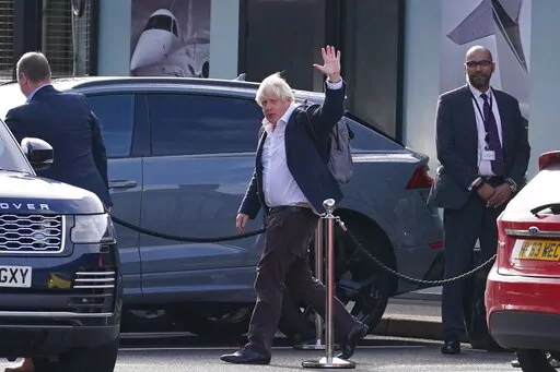 Former Prime Minister Boris Johnson arrives at Gatwick Airport in London, after travelling on a flight from the Caribbean, following the resignation of Liz Truss as Prime Minister, Saturday Oct. 22, 2022. (Gareth Fuller/PA via AP)