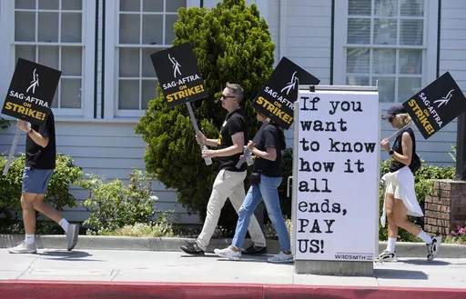 Picketers carry signs outside Amazon Studios in Culver City, Calif. on Monday, July 17, 2023. A tentative agreement between striking screenwriters and Hollywood studios offers some hope that the industry’s dual strikes may be over soon. (AP Photo/Chris Pizzello, File)