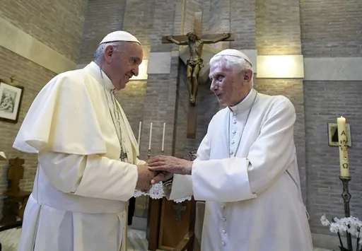 Pope Francis, left, and Pope Benedict XVI, meet each other on the occasion of the elevation of five new cardinals at the Vatican, on June 28, 2017. Pope Francis has exposed the political “maneuvers” to sway votes during the past two conclaves and denied he is planning to reform the process to elect a pope in a new book-length interview published Tuesday April 2, 2024. (L'Osservatore Romano/Pool photo via AP, File)