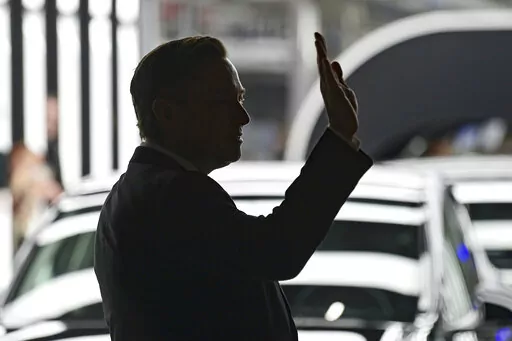 Elon Musk, Tesla CEO, attends the opening of the Tesla factory Berlin Brandenburg in Gruenheide, Germany, Tuesday, March 22, 2022.  Many people are puzzled on what a Elon Musk takeover of Twitter would mean for the company and even whether he’ll go through with the deal.  If the 50-year-old Musk’s gambit has made anything clear it’s that he thrives on contradiction.   (Patrick Pleul/Pool via AP, File)