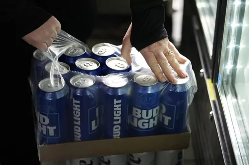 A stadium worker opens a case of Bud Light beer before a baseball game between the Philadelphia Phillies and the Seattle Mariners, Tuesday, April 25, 2023, in Philadelphia. (AP Photo/Matt Slocum)