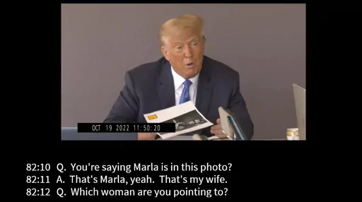 In this image taken from video released by Kaplan Hecker & Fink, former President Donald holds a photograph, presented as evidence during his Oct. 19, 2022 deposition, that shows E. Jean Carroll and her then-husband John Johnson meeting Trump and his wife Ivanka at an event in the 1980s. In his deposition, Trump mistook Carroll as Marla Maples, his now ex-wife, when shown the image. The video recording of Trump being questioned about the rape allegations against him was made public for the first