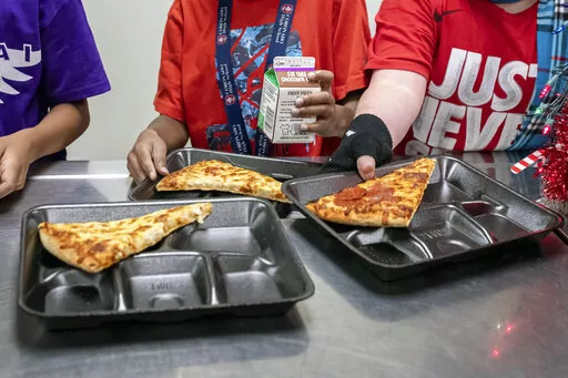 Second-grade students select their meals during lunch break in the cafeteria at an elementary school in Scottsdale, Ariz., Dec. 12, 2022. On Friday, Feb. 3, 2023, U.S. agriculture officials proposed new nutrition standards for school meals, including the first-ever limits on added sugars, with a focus on sweetened foods such as cereals, yogurt, flavored milk and breakfast pastries. (AP Photo/Alberto Mariani, File)
