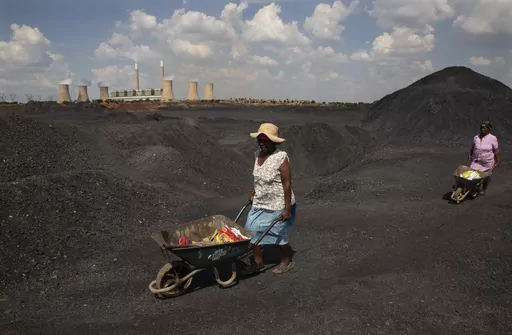 Women push wheelbarrows atop a coal mine dump at the coal-powered Duvha power station, near Emalahleni east of Johannesburg, Nov. 17, 2022. Humanity still has a chance, close to the last one, to prevent the worst of climate change’s future harms, a top United Nations panel of scientists said Monday, March 20, 2023. But doing so requires quickly slashing carbon pollution and fossil fuel use. (AP Photo/Denis Farrell, File)