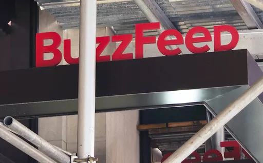 The entrance to BuzzFeed in New York is seen on Nov. 19, 2020. Pulitzer prize winning digital media company BuzzFeed is cutting about 15% of its staff, according to multiple media reports. In a memo sent to staff, co-founder and CEO Jonah Peretti said that the New York company was going to start the process of shutting down its news division, and that cuts would also occur across its business, content, tech and administrative teams. (AP Photo/Ted Shaffrey, File)