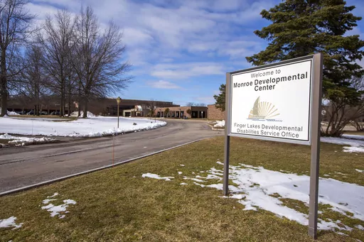 A sign for the Monroe Developmental Center at the Finger Lakes Developmental Disabilities Service Office on Wednesday, March 8, 2023, in Rochester, N.Y. A woman born to a severely disabled resident of the facility in 1986 has filed a lawsuit saying her mother was raped by an employee whose abuse was covered up by those in charge. (AP Photo/Lauren Petracca)