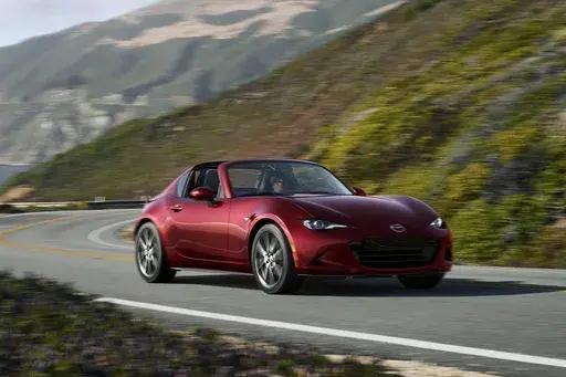 This photo provided by Mazda shows the 2024 MX-5 Miata. The refreshingly pure and elemental Mazda MX-5 Miata is proof that you don't need go-faster tech to have a great time. (Courtesy of Mazda North American Operations via AP)