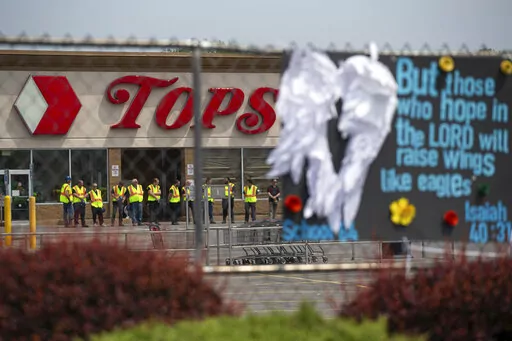Investigators stand outside during a moment of silence for the victims of the Buffalo supermarket shooting outside the Tops Friendly Market on May 21, 2022, in Buffalo, N.Y. The number of U.S. mass killings linked to extremism was at least three times higher in the last decade than the total from any 10-year period since the 1970s. That's according to a report released to The Associated Press by the Anti-Defamation League. (AP Photo/Joshua Bessex, File)