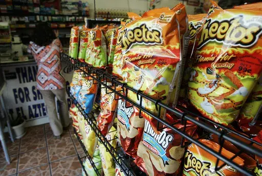 Flamin' Hot Cheetos are pictured near the front door of La Azteca Market in South Los Angeles, Aug. 22, 2008. The man who says he invented Flamin' Hot Cheetos filed a lawsuit against his former employers Thursday, July 18, 2024, for fraud, defamation and other violations, saying he was harmed when Frito-Lay and PepsiCo denied his role in creating the popular hot snack. (AP Photo/Reed Saxon)