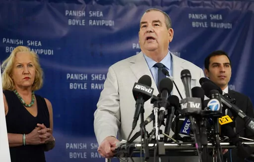 Randi McGinn, from left, Brian Panish and Jesse Creed, attorneys for the family of the late cinematographer Halyna Hutchins, take part in a news conference, Tuesday, Feb. 15, 2022, in Los Angeles. The family is suing Alec Baldwin and the movie producers of "Rust" for wrongful death, the attorneys said Tuesday. (AP Photo/Chris Pizzello)