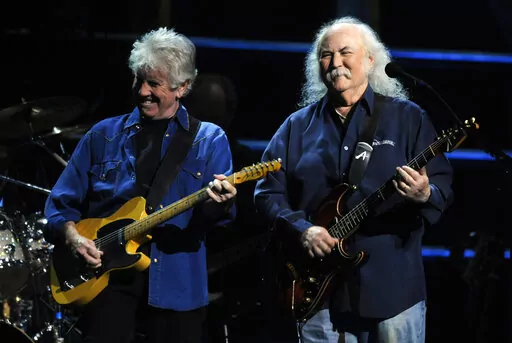 David Crosby, right, and Graham Nash perform at the 25th Anniversary Rock & Roll Hall of Fame concert at Madison Square Garden, Thursday, Oct. 29, 2009, in New York. Crosby, the brash rock musician who evolved from a baby-faced harmony singer with the Byrds to a mustachioed hippie superstar and an ongoing troubadour in Crosby, Stills, Nash & (sometimes) Young, has died at age 81. His death was reported Thursday, Jan. 19, 2023, by multiple outlets. (AP Photo/Henny Ray Abrams, File)